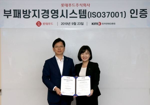 23일 롯데푸드 본사에서 진행된 ISO 37001 인증 수여식에서 롯데푸드 김재열 홈푸드사업본부장(왼쪽)과 한국경영인증원 황은주 대표이사(오른쪽)이 인증서를 들고 사진을 찍고 있다. [사진제공=롯데푸드]
