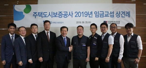 25일 이재광 HUG 사장(왼쪽 5번째)과 양호윤 위원장(왼쪽 6번째)이 2019년 임금교섭 상견례에서 기념촬영을 하고 있다. (사진제공=HUG)