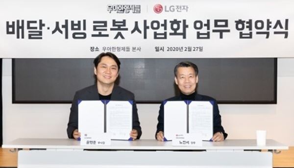 왼쪽부터 우아한형제들 신사업부문장 윤현준 부사장과 LG전자 로봇사업센터장 노진서 전무가 배달·서빙로봇 관련 사업협력을 위해 업무협약을 맺고 기념촬영을 하고 있다.